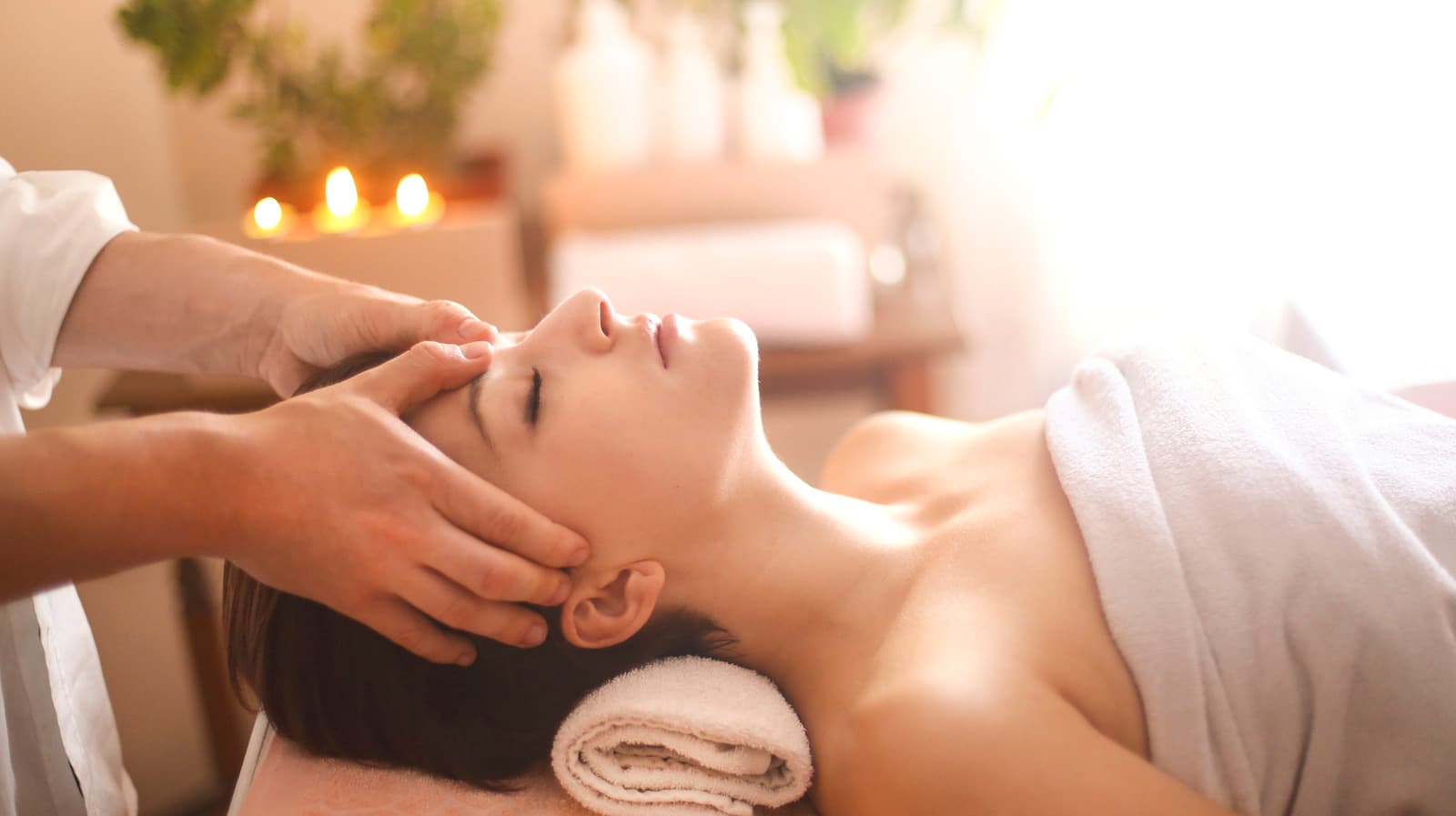 Restorative acupressure head, scalp and temple massage in a peaceful wellness atmosphere